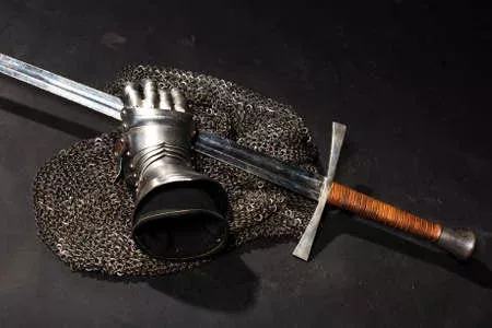 64285501-medieval-chain-mail-iron-gauntlet-and-a-bastard-sword-still-life-on-a-dark-background.webp.5927a41713aa163311b6d4fd762ea604.webp